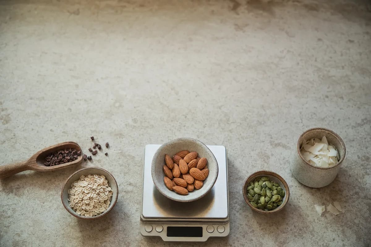A kitchen scale weighing raw ingredients, overhead flat lay