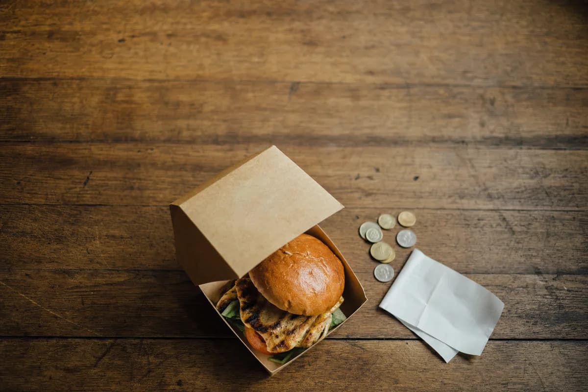 Loose coins and a folded slip of paper on a table